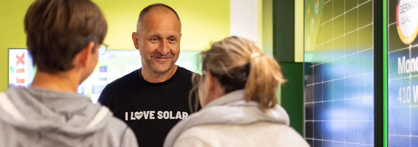 Ein enerix Photovoltaik und Wärmepumpen Berater berät eine junge Frau und einen jungen Mann